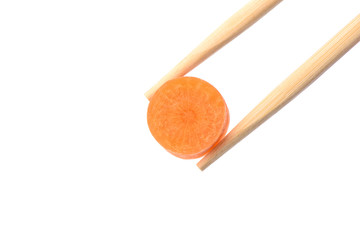 Chopsticks with a circle of ripe carrots isolated on white background.