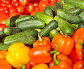 fresh peppers, tomatoes and cucumbers at the market
