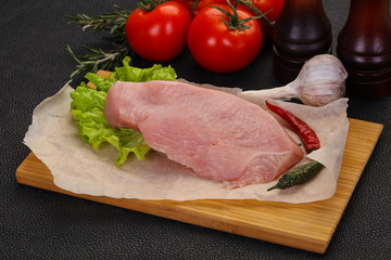 Raw Turkey steak served rosemary