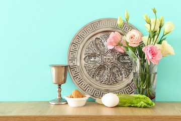 Pesah celebration concept (jewish Passover holiday). Translation for Hebrew Text over plate: (PESAH) PASSOVER