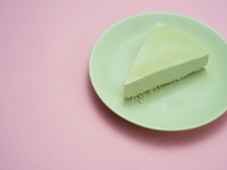 Green tea cheesecake on a green plate.