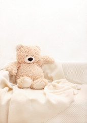 Children's toys - bears of brown and beige color are sitting on the sofa.