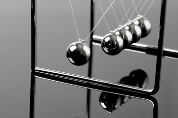 Newtons Cradle balancing balls, business concept in studio