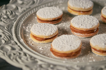 cookie caramel alfajores closeup in ornamented plate over a table