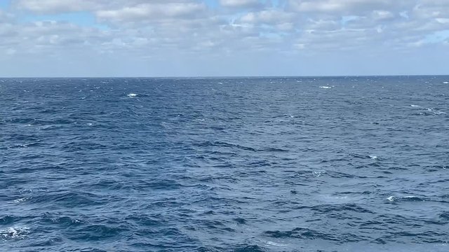Somewhat rough open seas on a clear day water background with copy space