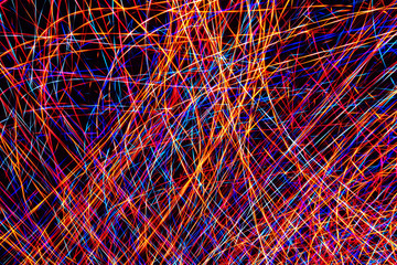Colorful light painting abstract long exposure image with pink, blue, red and yellow lines on a...