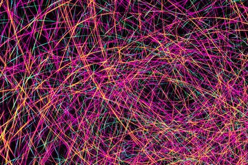 Colorful light painting abstract long exposure image with pink, blue, red and yellow lines on a...