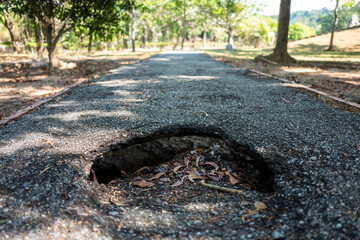 Hole in boardwalk of Langkawi Lagenda Park in Malaysia