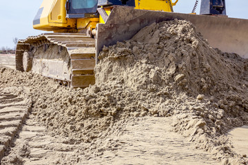 Crawler's tracks, bulldozer machine is leveling construction site