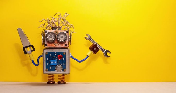 Funny robot handyman technician rotates saw and hand wrench. Fixing maintenance concept. Creative design robotic toy character. Yellow wall floor background. Copy space