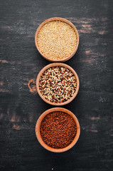 Set of quinoa Red, white and brown quinoa. On a black background. Top view. Free copy space.