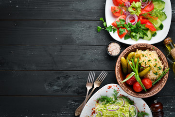 Set salads and pickled vegetables on a plate. On the old background. free copying space.