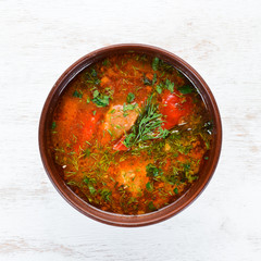 Harcho soup with meat and tomatoes. Ukrainian cuisine. Top view. Free space for your text. Rustic style.