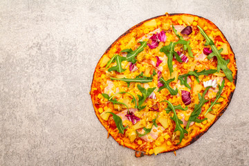 Hot homemade Hawaiian pizza on stone background top view copy space.