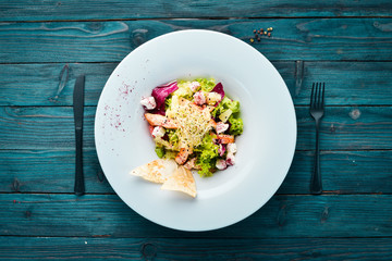 Vegetable salad with chicken fillet, pineapple and feta cheese. In the plate. Top view. Free space for your text. Rustic style.