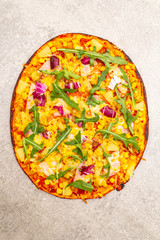 Hot homemade Hawaiian pizza on stone background top view close up.