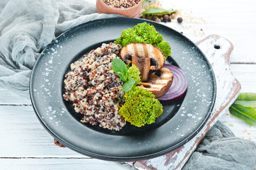 quinoa with mushrooms and vegetables on a plate. Top view. Free space for your text.