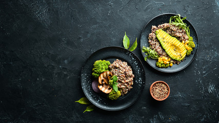 Boiled quinoa with avocado and vegetables. Top view. Free space for your text.