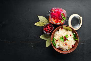 Sauerkraut in a jar on a kitchen table. Cabbage, cauliflower. Top view. Free space for your text.