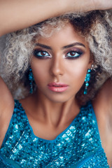 Close-up portrait of mixed woman with bright make-up