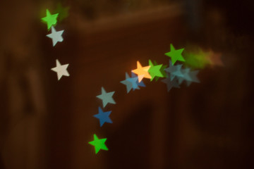 neon light of Christmas garlands in the form of stars on a dark background