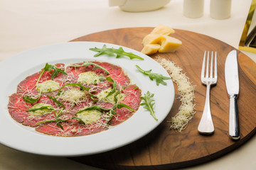 Carpaccio with arugula in restaurant