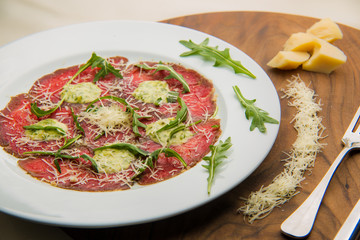 Carpaccio with arugula in restaurant