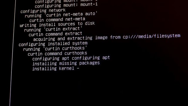 Computer screen shows "installing kernel" and other technical messages during configuration of the Linux operating system.