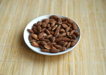 Healthy food  for background image close up almond nuts. Texture Nuts on the cup plate