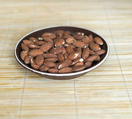 Healthy food  for background image close up almond nuts. Texture Nuts on the cup plate
