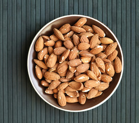 Healthy food  for background image close up almond nuts. Texture Nuts on the cup plate