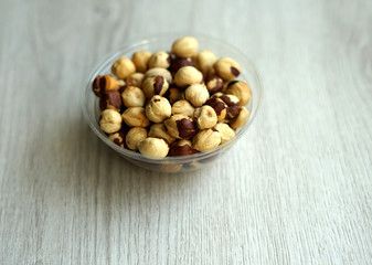Healthy food  for background image close up hazelnuts.  Nuts texture on white grey table top view