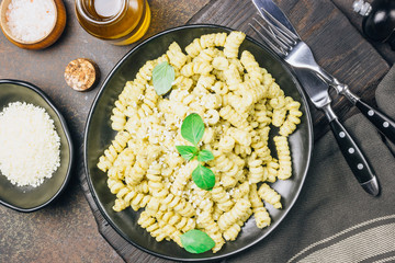 Fusilli pasta with basil, pesto sauce and parmesan cheese