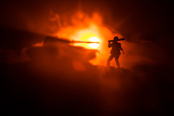 Fototapeta premium Military soldier silhouette with bazooka. War Concept. Military silhouettes fighting scene on war fog sky background, Soldier Silhouette aiming to the target at night