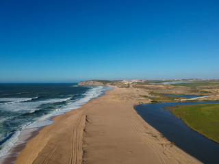 Aerial view from a sandy beach with river arm. Portugal