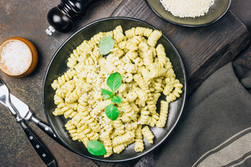 Fusilli pasta with basil, pesto sauce and parmesan cheese