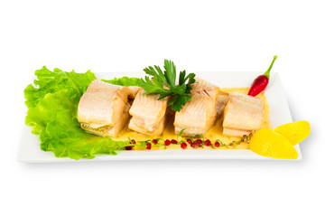Dish of fish with greens and lemon isolated