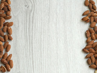 Healthy food  for background image close up almond nuts. Texture on white grey table top view