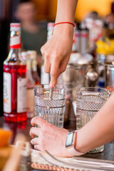 female bartender preparing cocktail in a cocktail bar