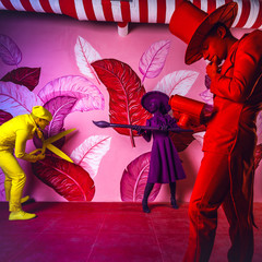 Group of stylized fantasy actors in scenic make-up and bright colored background. 