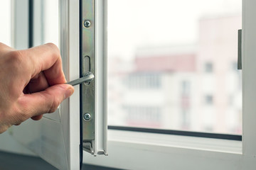 Workman adjusts the operation of the plastic window.