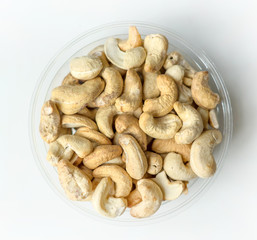 Healthy food  for background image close up cashew nuts.  Nuts texture on white grey table top view on the cup plate