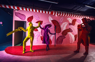 Group of stylized fantasy actors in scenic make-up and bright colored background. 
