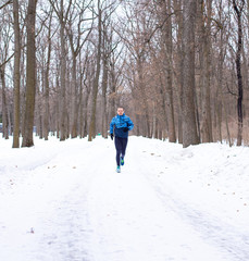 Adult man sportsman runner running in forest