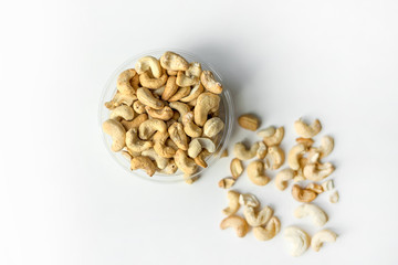 Healthy food  for background image close up cashew nuts.  Nuts texture on white grey table top view on the cup plate