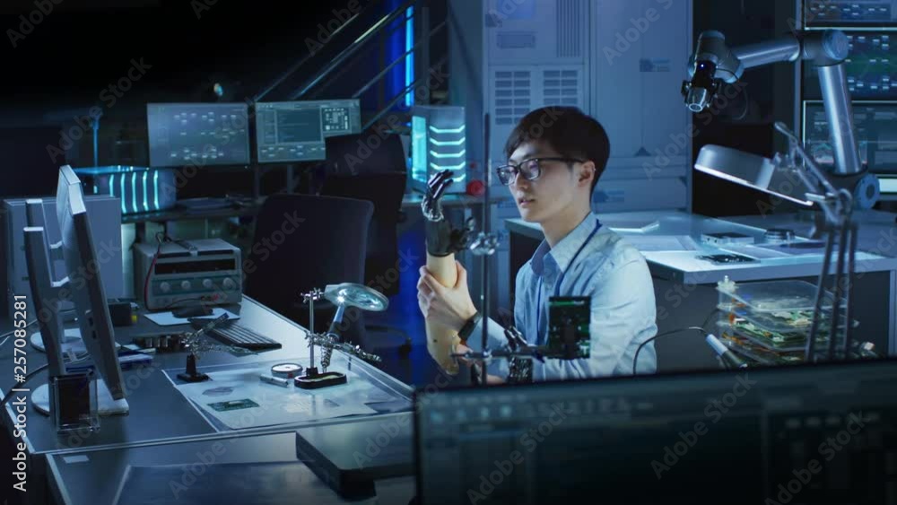 Aufkleber Futuristic Prosthetic Robot Arm Being Tested by a Professional Japanese Development Engineer in a High Tech Research Laboratory with Modern Computer Equipment.
