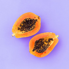Half cut papaya on color background