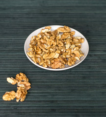 Healthy food  for background image close up walnuts.  Nuts  texture on top view on the cup plate