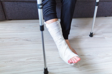 The man is trying to walk with a broken leg