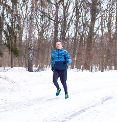 Outdoor winter running. Man runner do his training